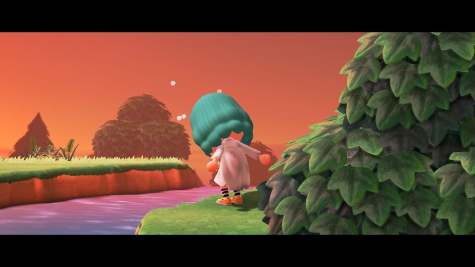 Schermata di me su Animal Crossing New Horizons che starnutisco in riva al fiume al tramonto, forte zoom, cornice film